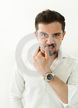 A very angry man is looking straight in the camera. picture is made in a high contrast effect. picture is toned