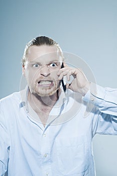 Very angry man on telepone