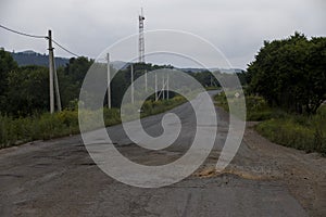 Very bad road in Russia. The asphalt road is all in holes in the middle of the forest.