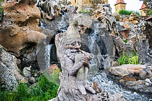 Very beautiful artificial waterfalls with living water and growing moss. Water flows from above, splashes and drops around