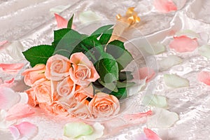 Very beautiful delicate pink roses with petals lie on the bed, a romantic bouquet of pink roses on white sheets