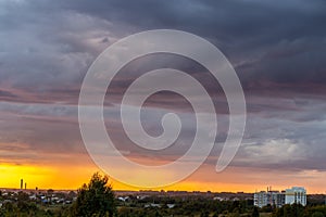 Very beautiful sunset in the city or village. Pink-orange sky with clouds