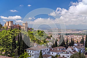 Very beautiful view of Alhambra, Sacromonte and the city of Granada with bright blue sky and white nubes photo