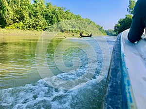 Very beautiful green nature with blue sky and speed boat overflow water