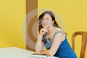 Very beautiful woman smiling sitting on a chair