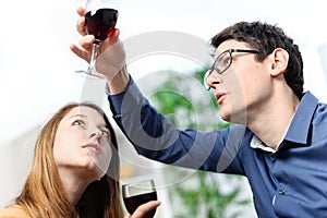 Very beautiful young couple toasting wine glasses