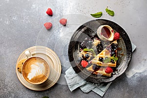 Very Berries Waffle with blueberry, raspberry, strawberry, espresso coffee and cookies served in dish isolated on table top view