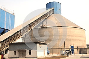 a big clinker storage silo with a conveyor photo