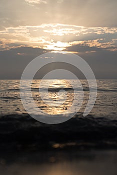 A very calm Baltic sea water surface with reflections of the sun.