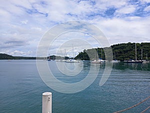 very calm sea surrounded by islands clear sky with road leading to the island