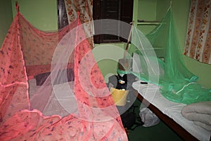 A very cheap budget hotel for two in Kathmandu with a mosquito net over the bed. Backpack near the bed