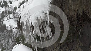 Very close up view of icicles of ice with falling drops