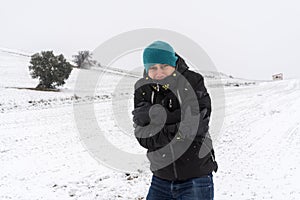 Very cold man in the middle of a snowfall