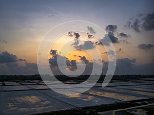 Romantic clouds gathering at colorful evening near saltpan