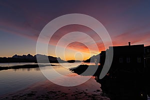 Very colourful and beautiful sunrise and morning light over Norwegian fisherman\'s hut in Lofoten, Norway