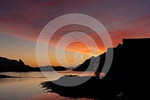 Very colourful and beautiful sunrise and morning light over Norwegian fisherman\'s hut in Lofoten, Norway