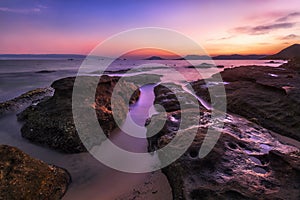 very colourful sunset over rocks on the coast on phu quoc in vietnam