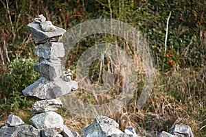 Very complicated balance stone tower on a stone fence. Concept concentration, passionate, stamina. Nature background