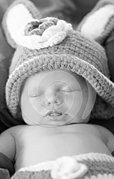 Black white portrait close-up newborn baby sleeping in bunny costume