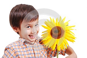 Very cute boy hugging sunflower as friend