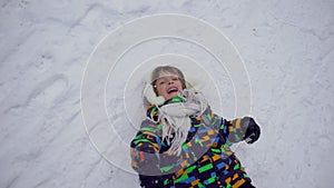 A very cute happy little boy in the Park in winter. Winter time. Happy boy having fun in a snow winter park. He is happy