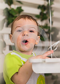 A very cute young surprised boy looking at camera