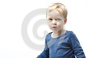 A very cute young surprised boy looking at camera, Isolated on white.