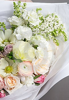 Very delicate handmade bouquet in the hands of the girl florist, a great gift, fresh and neat, interesting gradient