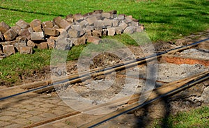 Very demanding repair of a turnout in a bend. the paving blocks were removed in order to strengthen the subsoil and access the rai