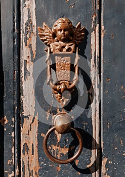 An amazing angel-shaped heavy iron door handle on a random house in Brugge, Belgium