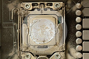 Very dirty computer processor. Dusty CPU microchip on a computer motherboard with traces of cooler grease. The electronic board in