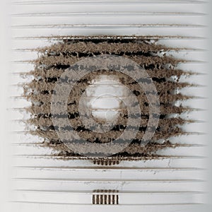 Very dirty and dusty white plastic ventilation grill. Ventilation shaft in the apartment. dirty air filter. House cleaning concept