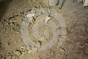 Very dirty floor after renovating the house made of clay. Dirt during repairs. Sprinkled clay from the walls. Renovation