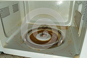 Very dirty inner surface microwave after spilled sweet coffee