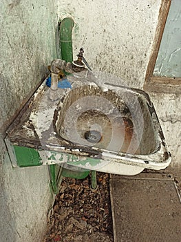 Very dirty old sink and faucet on the street in Central Asia