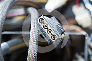 Very dirty wires, connectors and plugs in the computer. Old multi-colored wires in a braided wrapper. Stranded electrical wire