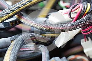 Very dirty wires, connectors and plugs in the computer. Old multi-colored wires in a braided wrapper. Stranded electrical wire