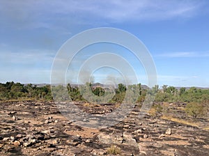 Very dry landscape around Darwin, Australia twith smoke from an old fire in the background