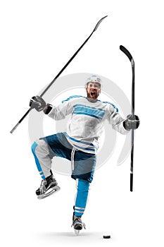 Very emotional hockey player with sticks in his hands. Sports emotions. Athlete in action. Hockey athlete with desire to