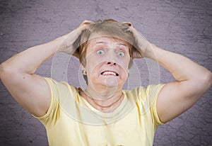 Very emotional woman on a gray background