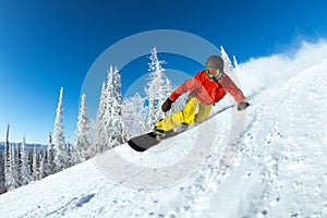 Very fast snowboarder slides at ski slope