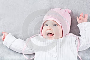 Very funny girl in a pink knitted hat