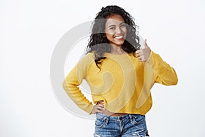 Very good, girl encourage you made great choice. Smiling confident and energized pretty woman wear yellow sweater, show