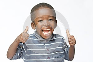 Very happy African black boy making thumbs up sign with hands laughing happily African ethnicity black boy isolated on white