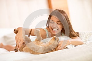 Very happy brunette play with her puppy pet