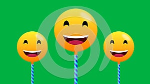 Very happy and laughing emoji animation in swinging motion on green background