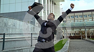 Very happy mulatto office employee shouting joyfully, career promotion success
