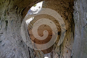 Very high cave with holes on the ceiling in the form of eyes 2