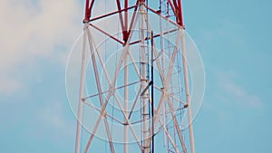 Very high radio tower with transmitting VHF and UHF equipment. Cellular link radio transmitters. Steel tower structure painted in