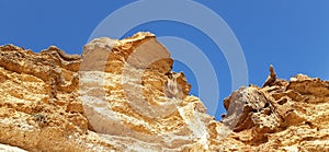 Very high sandstone cliff and blue sky